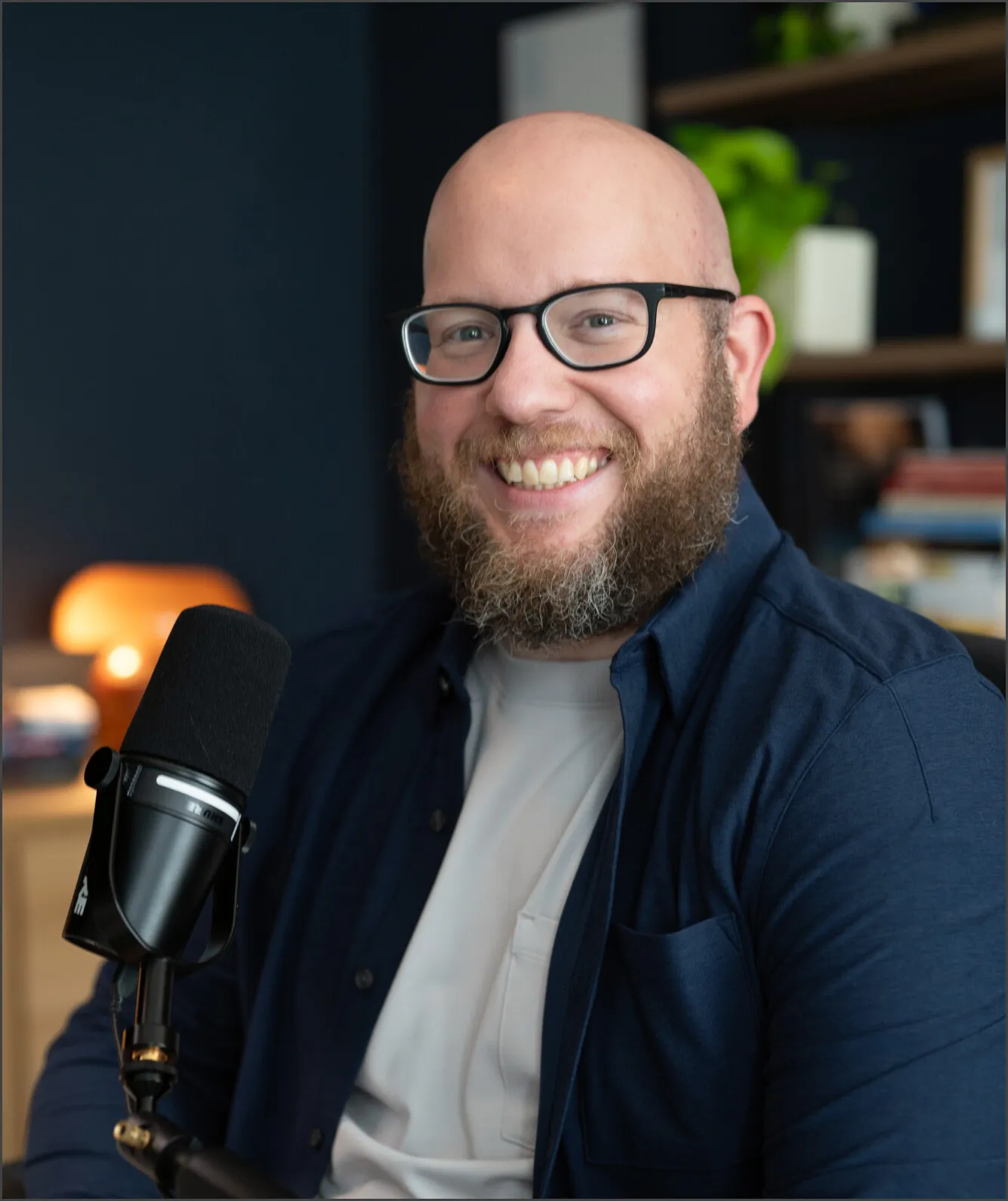 Damian Galarza at his desk, smiling at the camera next to a podcast microphone